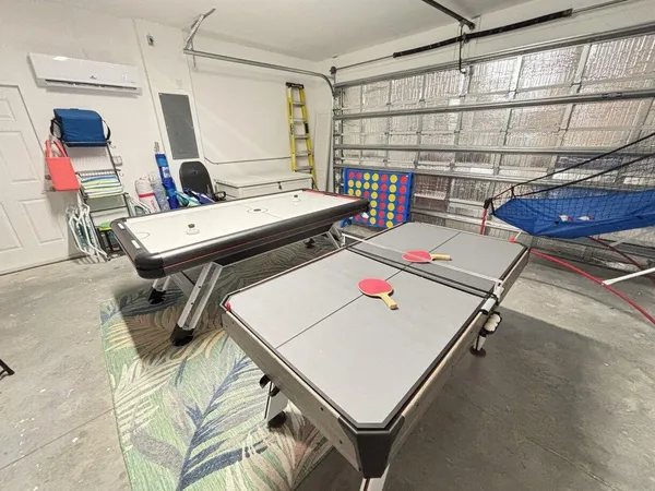 a reading room with furniture pool table and a window