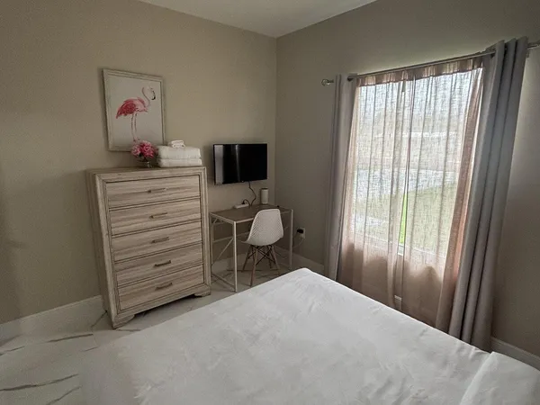 a bedroom with a bed and a window
