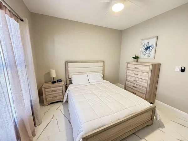 a bedroom with a bed and a view of closet