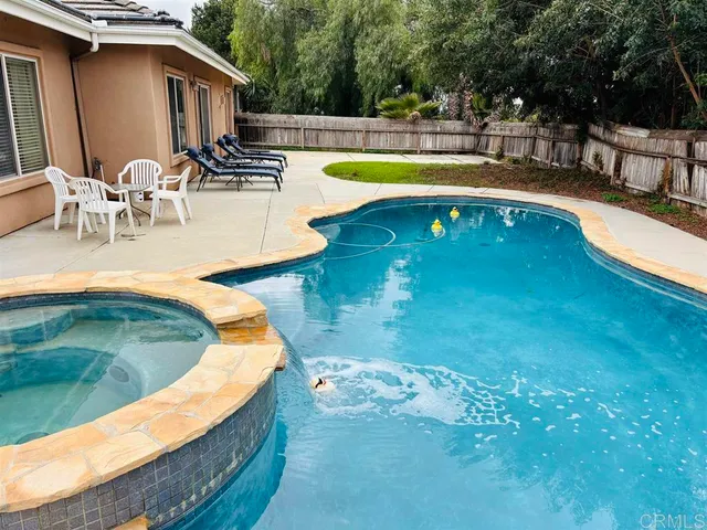 a view of a swimming pool with a patio
