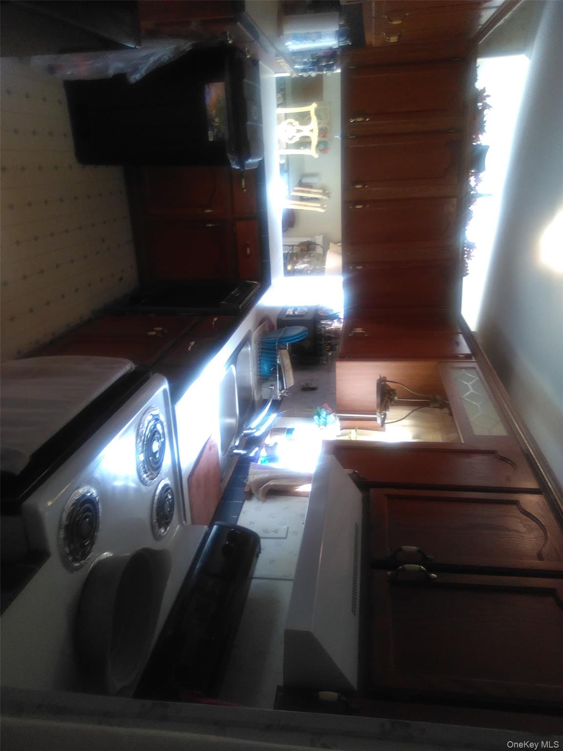 2032 Champlin Road Jefferson, NY 12093 - Photo 13 of 20 Kitchen featuring white range, range hood, light floors, dishwashing machine, and light countertops
