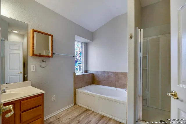 a bathroom with a bathtub and a sink