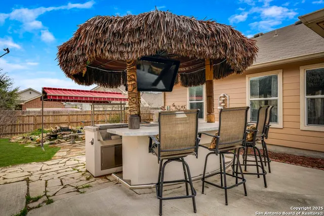 a view of a chairs and table in the patio