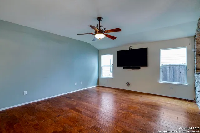 a view of a livingroom with a flat screen tv and wooden floor