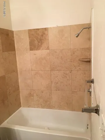 a bathroom with a sink a toilet and bathtub