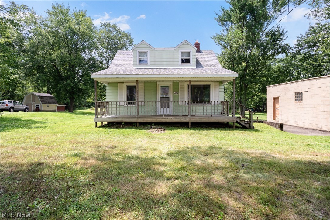 6324 Struthers Road Youngstown, OH 44514 - Photo 2 of 42 Two-story residence featuring a covered front porch with railings, two dormer windows, and light green siding