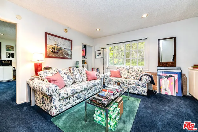 a view of a chairs and table in a back yard of the house