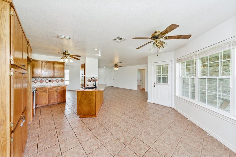 4316 Leona Road Bowie, TX 76230 - Photo 7 of 37 a view of kitchen with cabinets and window