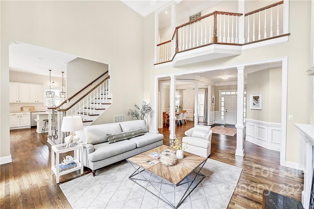 2826 Sharon Road Charlotte, NC 28211 - Photo 20 of 47 a living room with furniture a rug and a chandelier