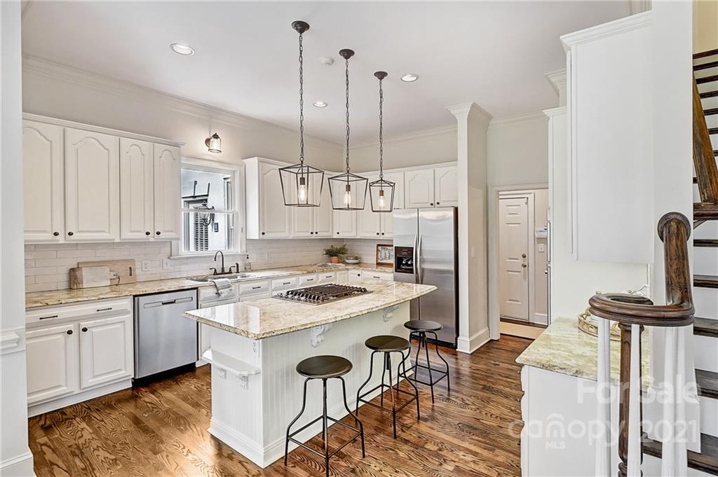 2826 Sharon Road Charlotte, NC 28211 - Photo 26 of 47 a kitchen with a sink a stove a refrigerator and island