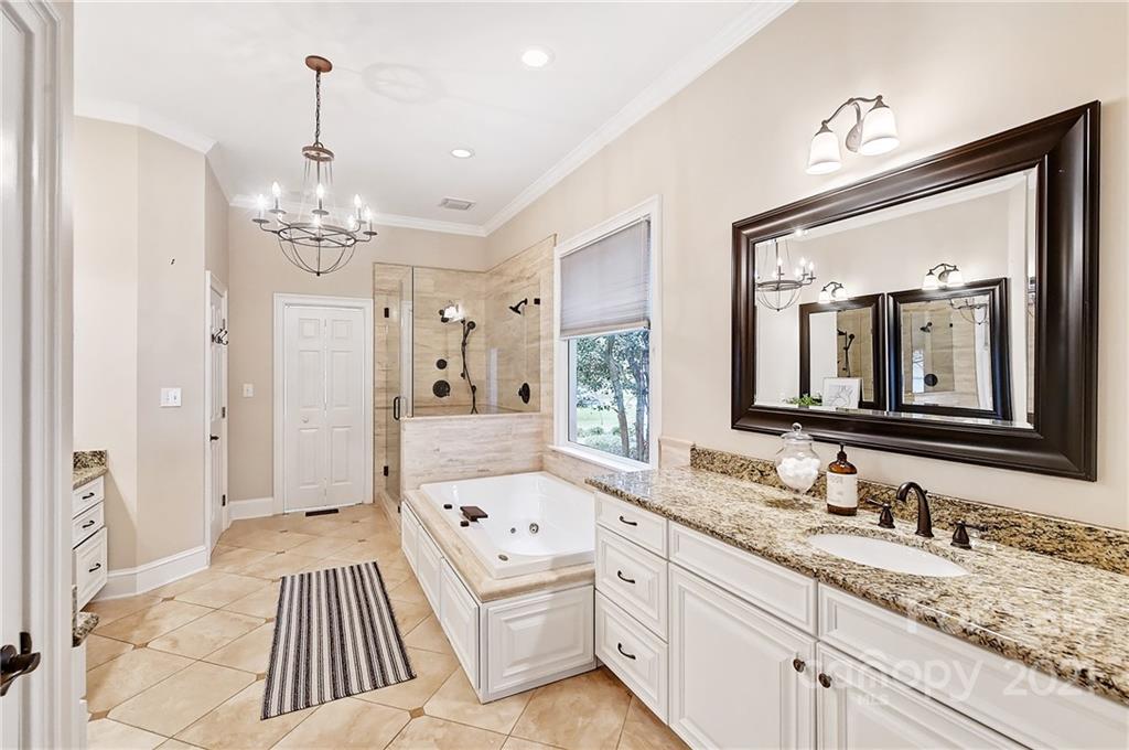 2826 Sharon Road Charlotte, NC 28211 - Photo 32 of 47 a spacious bathroom with a granite countertop sink mirror and shower