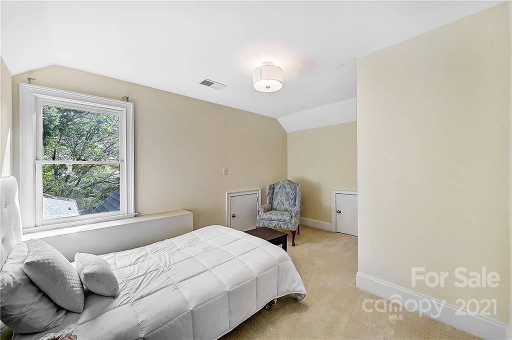 2826 Sharon Road Charlotte, NC 28211 - Photo 42 of 47 a bedroom with a bed and wooden floor