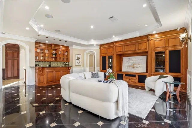 a kitchen with stainless steel appliances granite countertop a refrigerator a oven a sink with island chairs and wooden cabinets