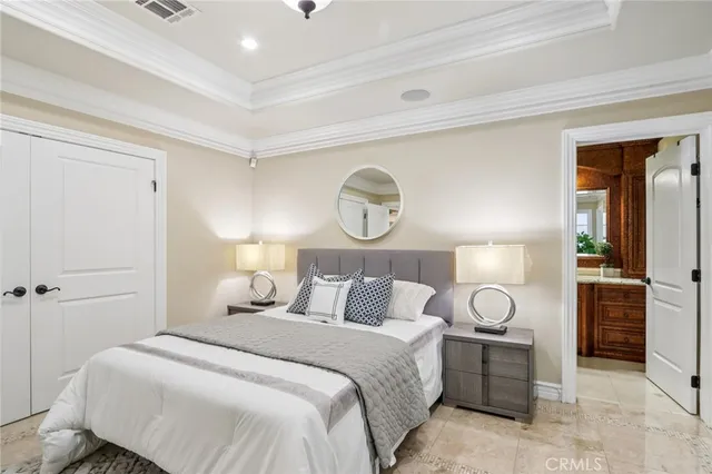 a bedroom with a bed and a potted plant