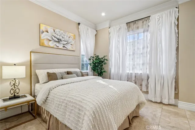 a bedroom with a large bed and a large mirror