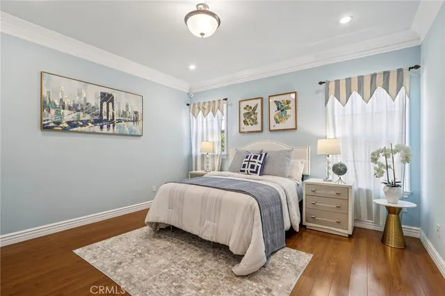a view of a white house with a yard and large tree