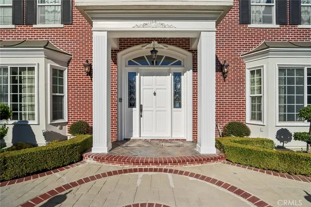 a view of a hallway with wooden floor and windows