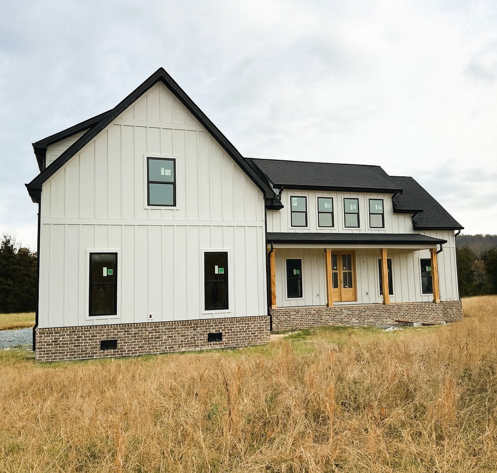 a view of a white house with large windows