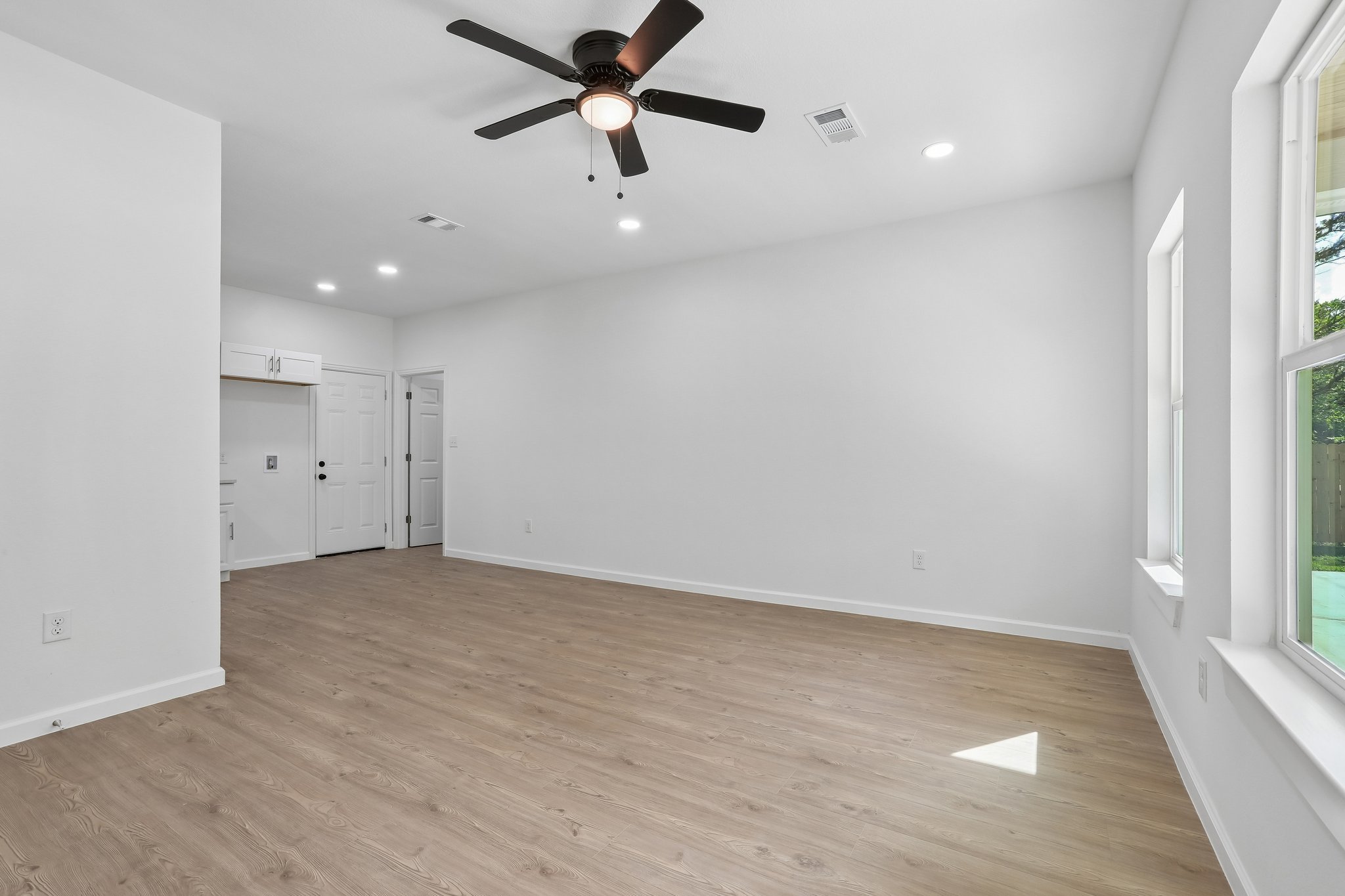 210 Flint Ridge Street Bastrop, TX 78602 - Photo 9 of 40 wooden floor in an empty room with a window