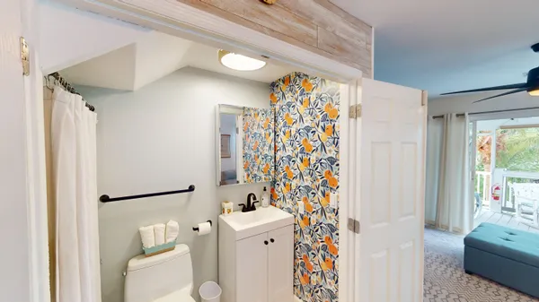 a bathroom with a sink toilet and shower