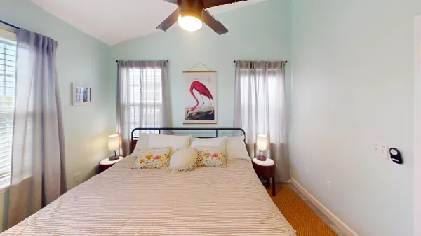 a bedroom with a large bed and a chandelier