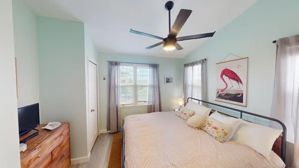 a bedroom with a bed and a flat screen tv