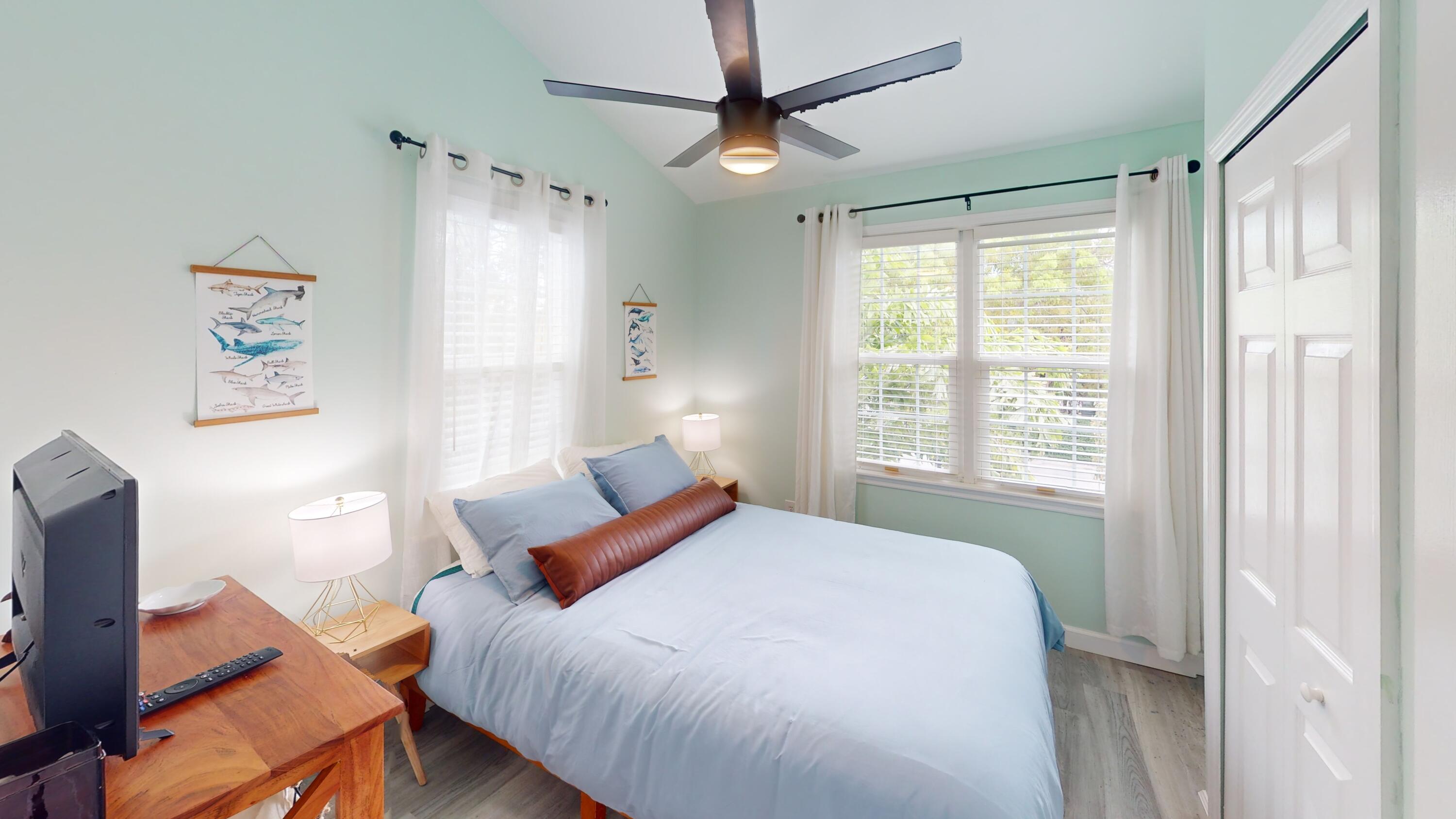 48 Merganser Lane Key West, FL 33040 - Photo 17 of 29 a bedroom with a bed ceiling fan and a window