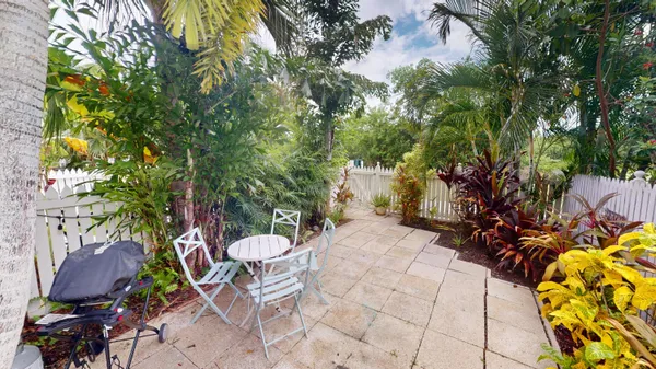 a view of a chairs and table in a patio