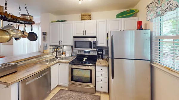 a kitchen with a white stove and refrigerator