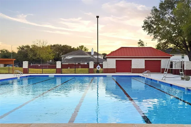 a view of a swimming pool with a yard