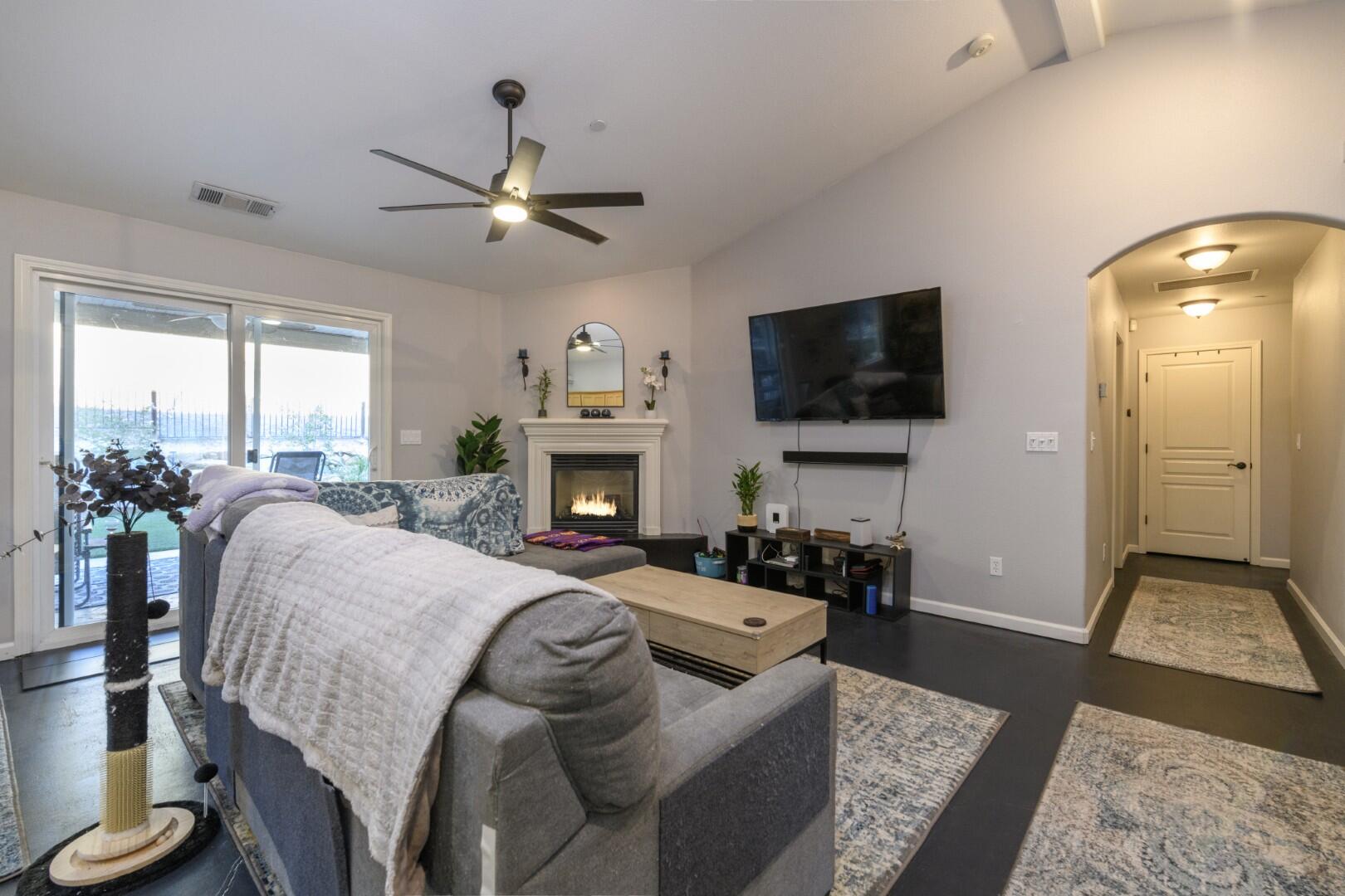 671 Valleybrook Drive Redding, CA 96003 - Photo 13 of 20 a spacious bedroom with a balcony a bed and a flat screen tv