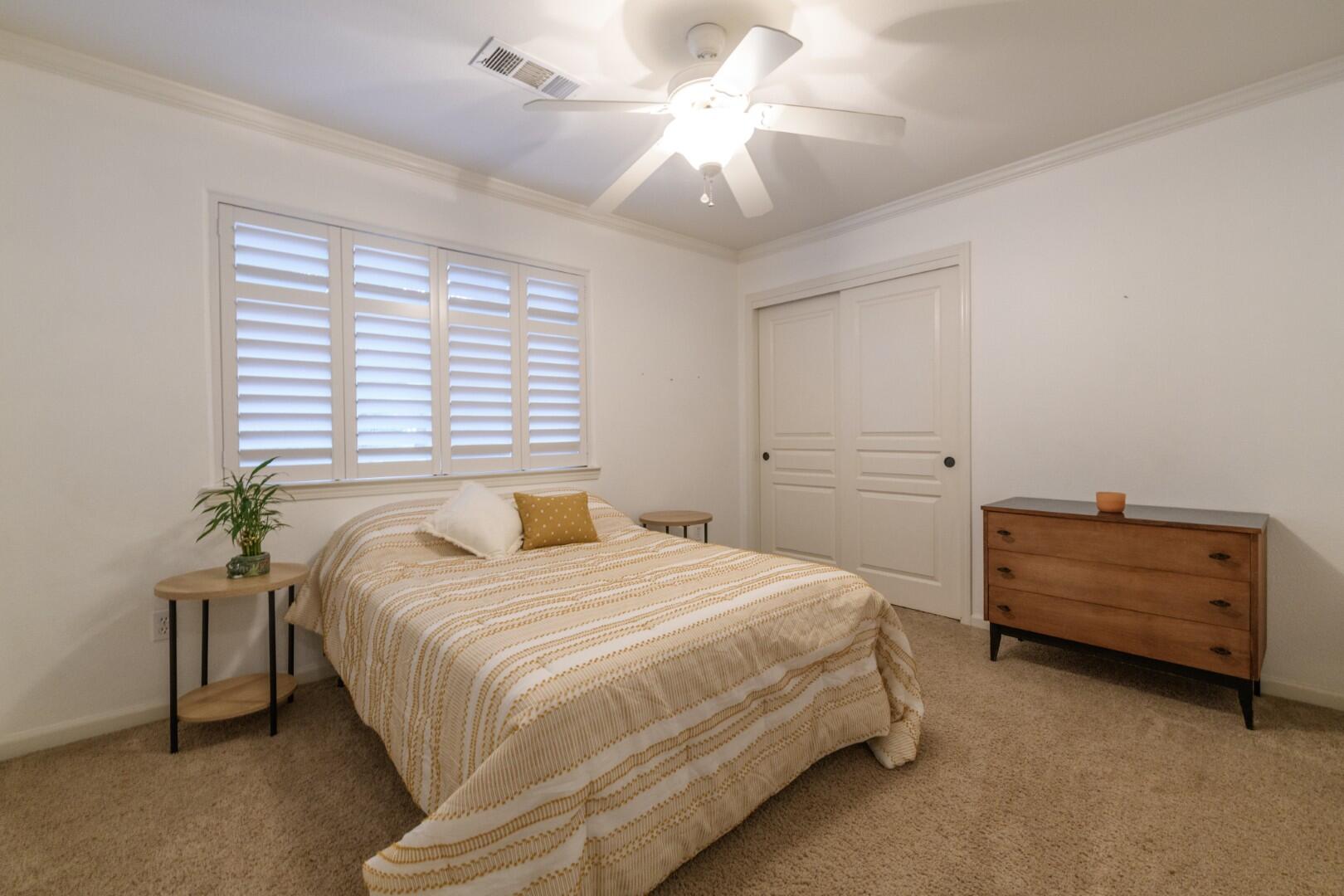671 Valleybrook Drive Redding, CA 96003 - Photo 14 of 20 a bedroom with a bed and a chandelier