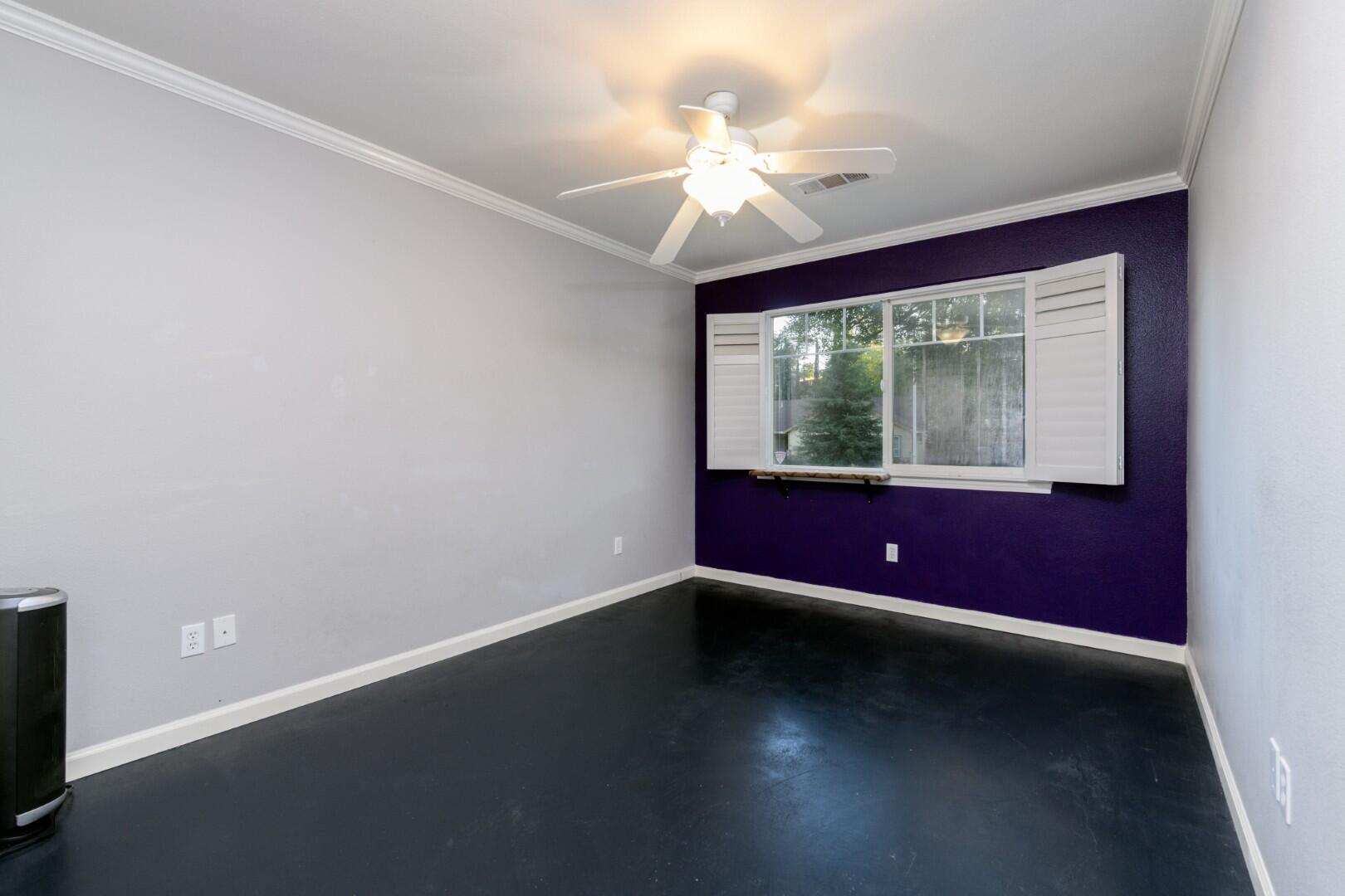 671 Valleybrook Drive Redding, CA 96003 - Photo 16 of 20 an empty room with wooden floor and windows
