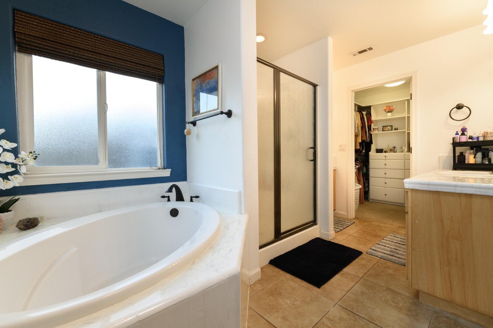 671 Valleybrook Drive Redding, CA 96003 - Photo 8 of 20 a bathroom with a bathtub and a shower