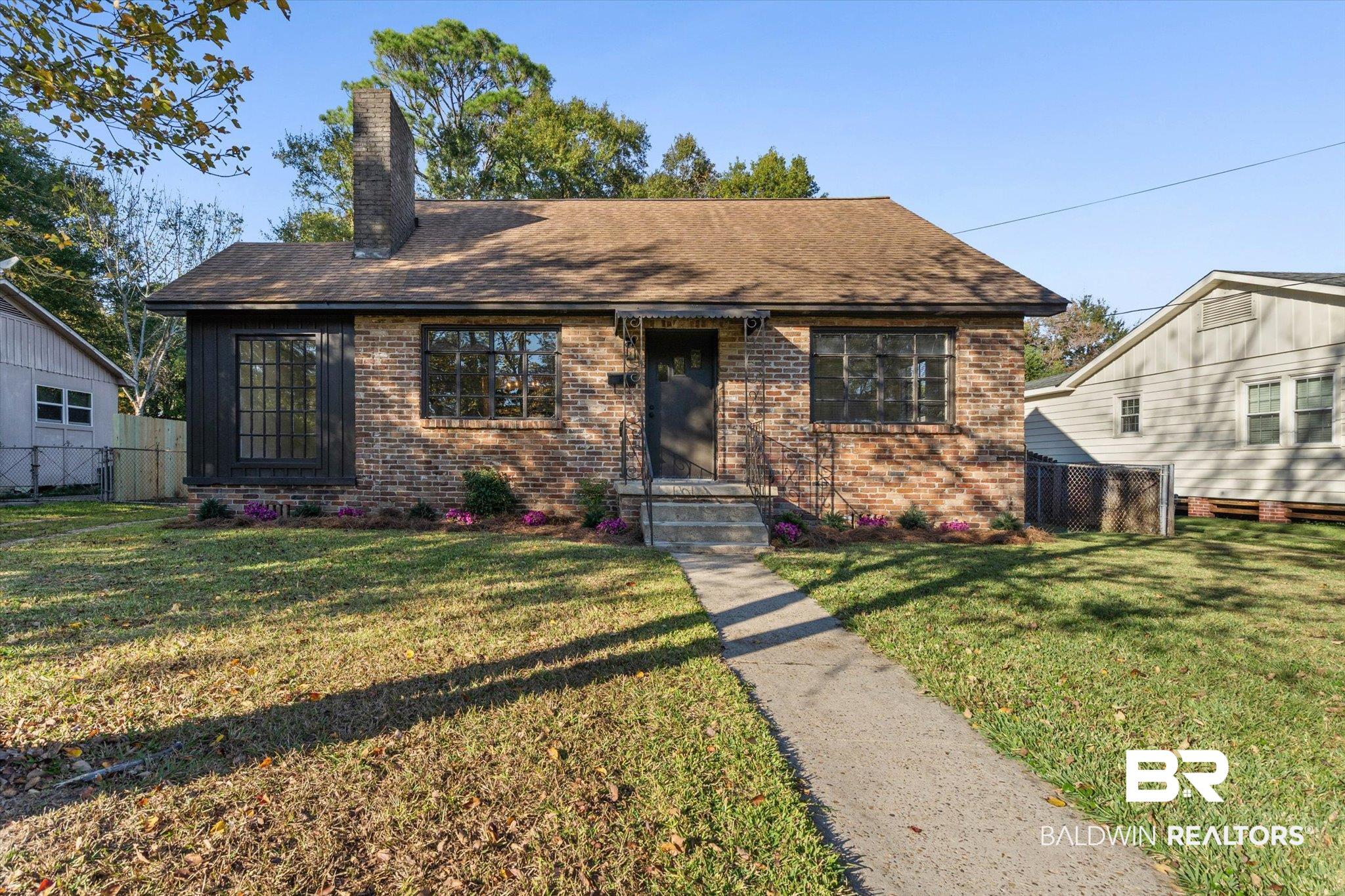 2806 Exter Drive Mobile, AL 36606 - Photo 21 of 24 View of front of property with brick siding, a chimney, and a shingled roof