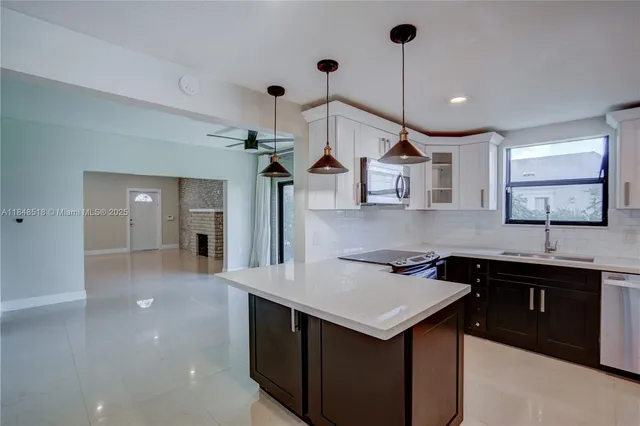 a kitchen with a sink a stove and cabinets
