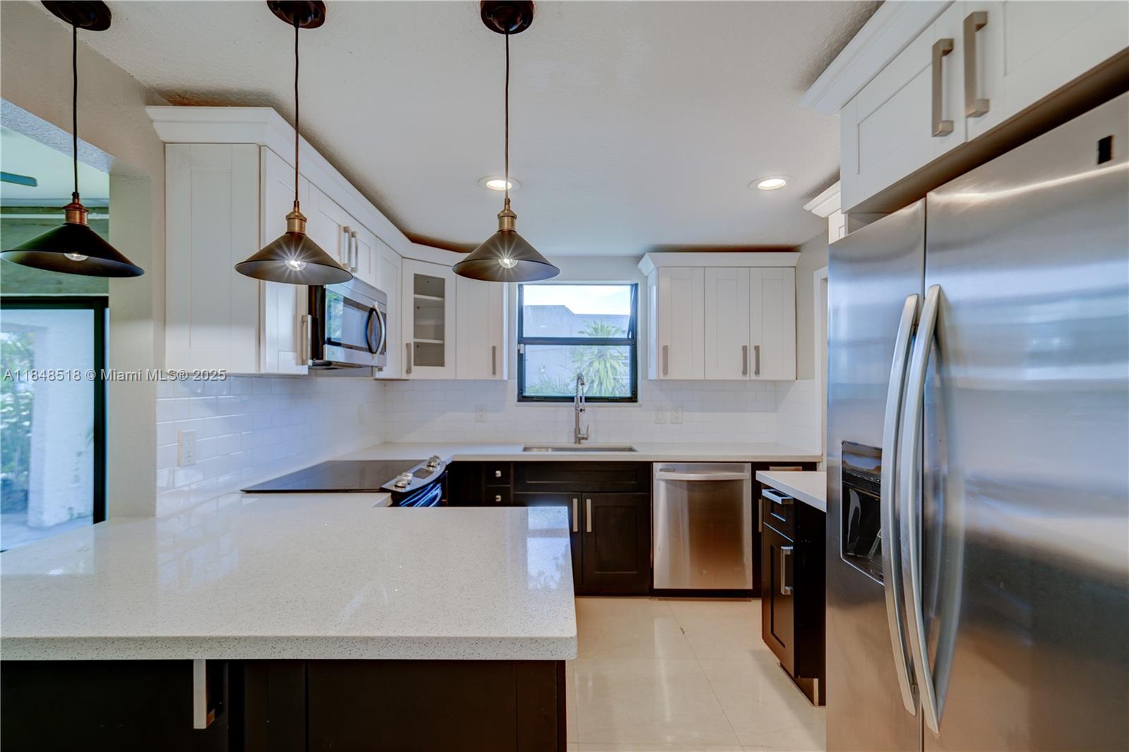 2217 Red Road Coral Gables, FL 33155 - Photo 14 of 33 a kitchen with stainless steel appliances a sink a stove a refrigerator and island