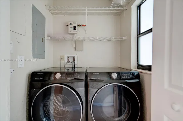 a utility room with sink dryer and washer