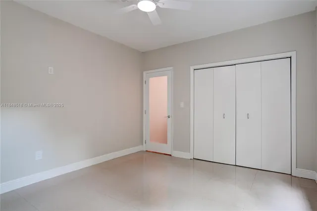 a view of an empty room with a fan