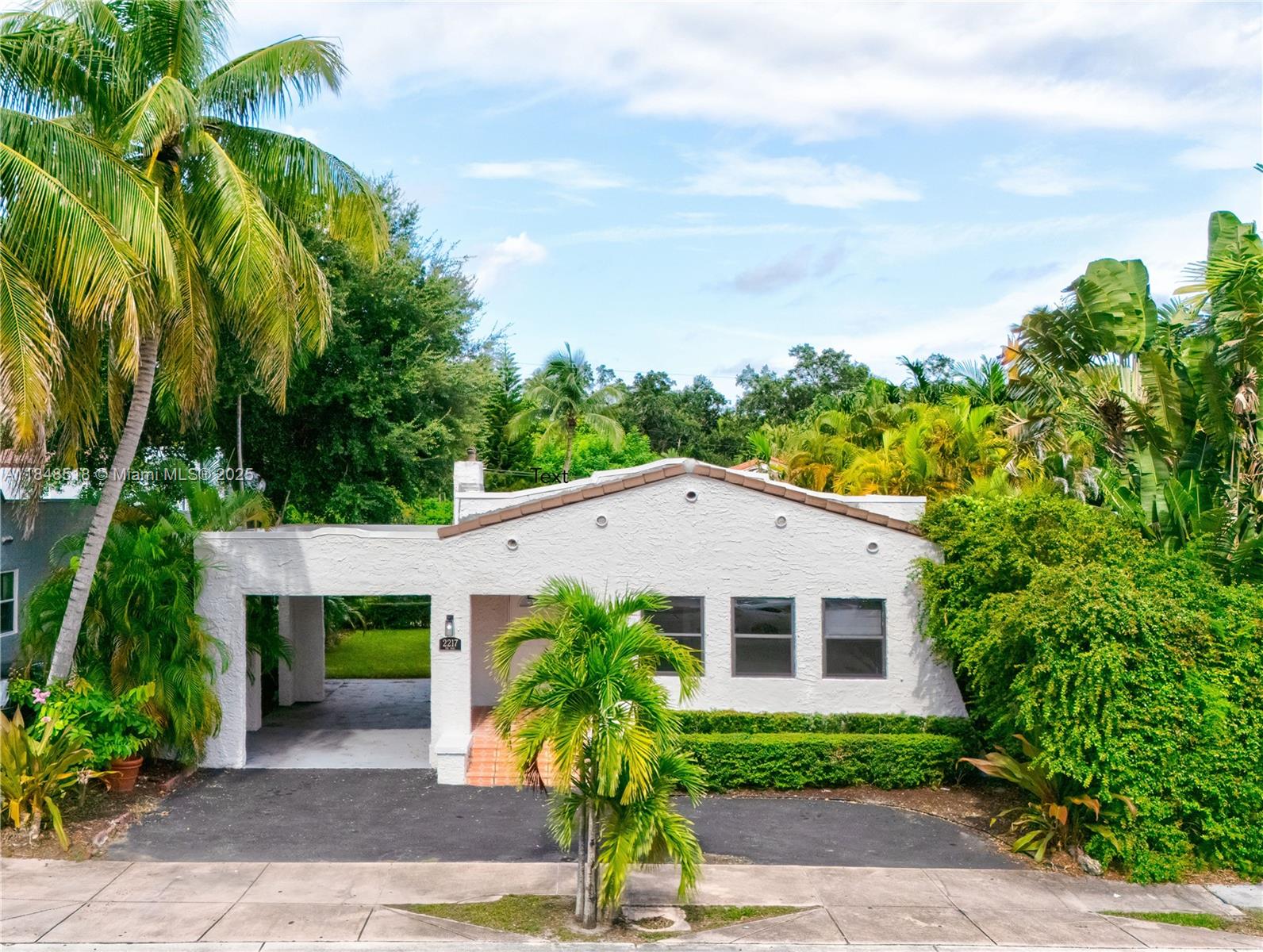 2217 Red Road Coral Gables, FL 33155 - Photo 2 of 33 a front view of a house with garden