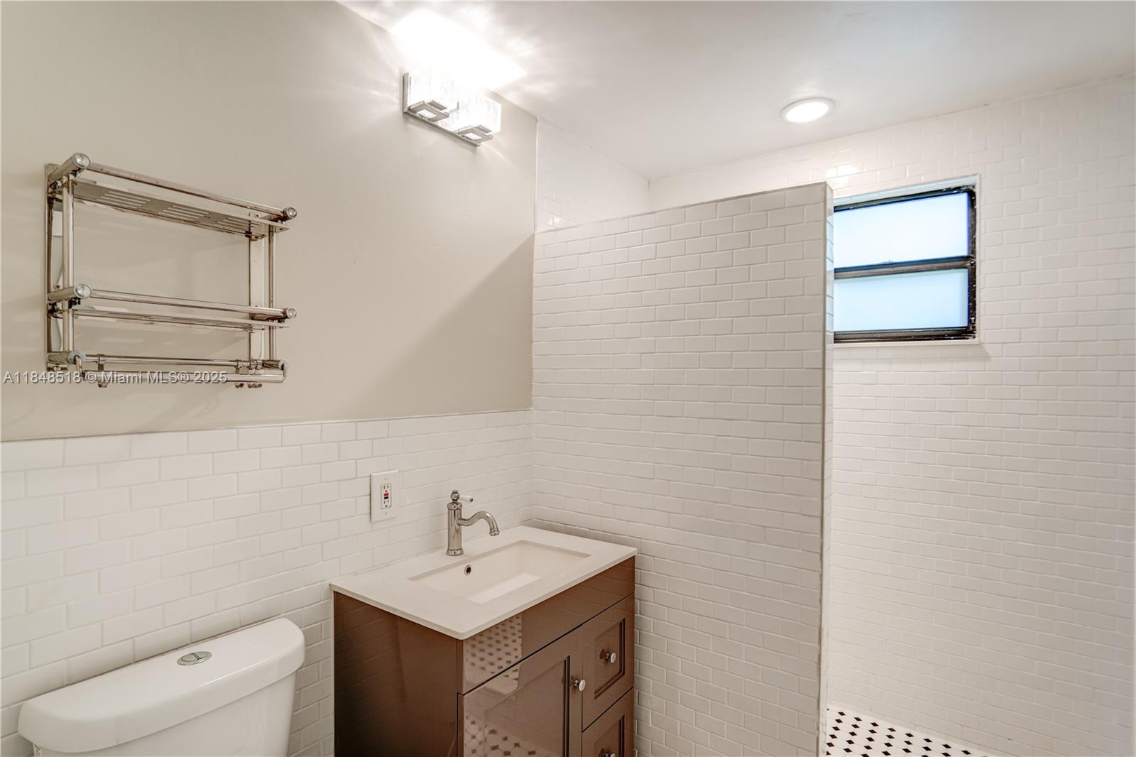 2217 Red Road Coral Gables, FL 33155 - Photo 23 of 33 a bathroom with a sink a toilet and mirror
