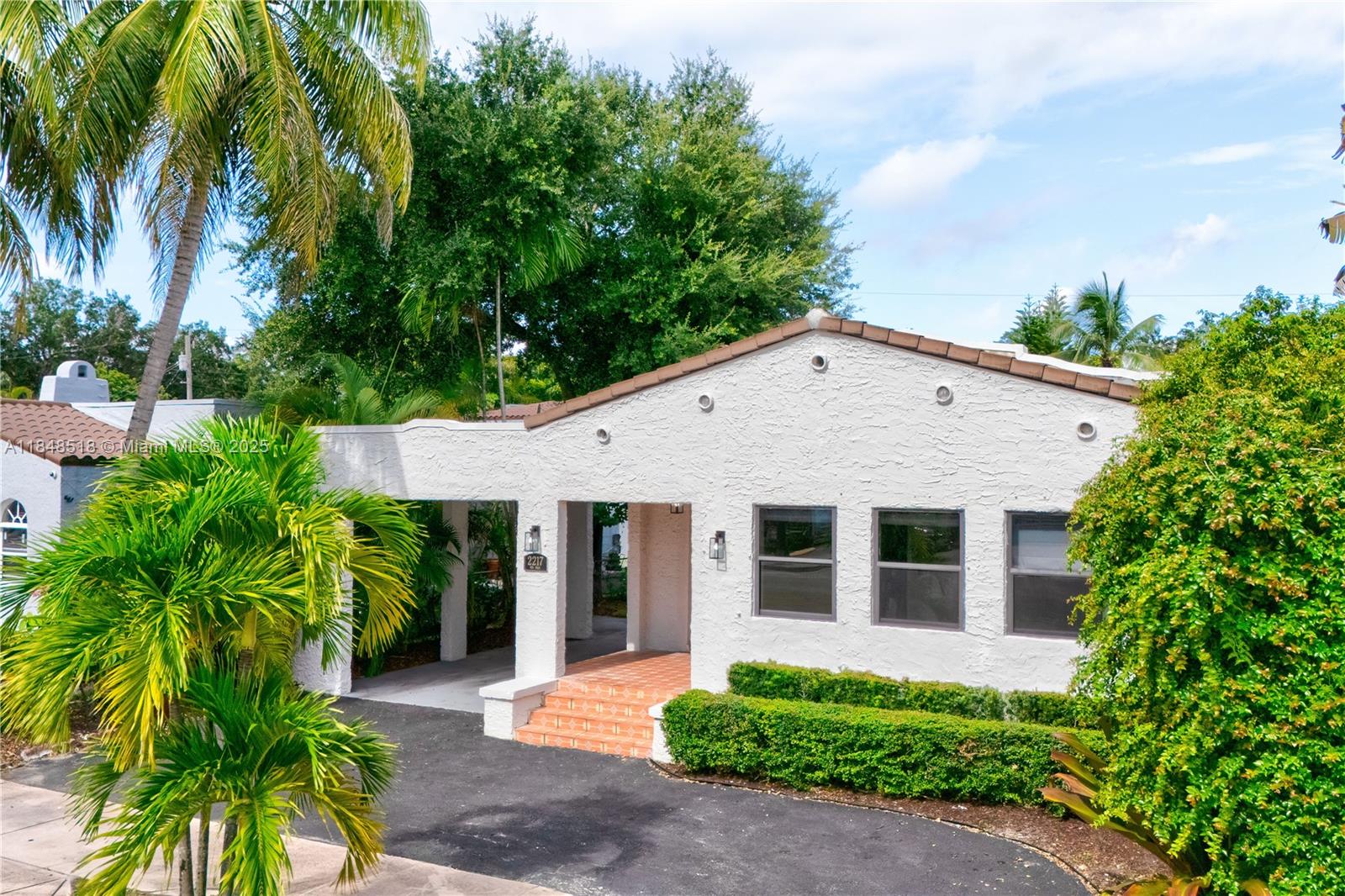 2217 Red Road Coral Gables, FL 33155 - Photo 4 of 33 a front view of a house with garden