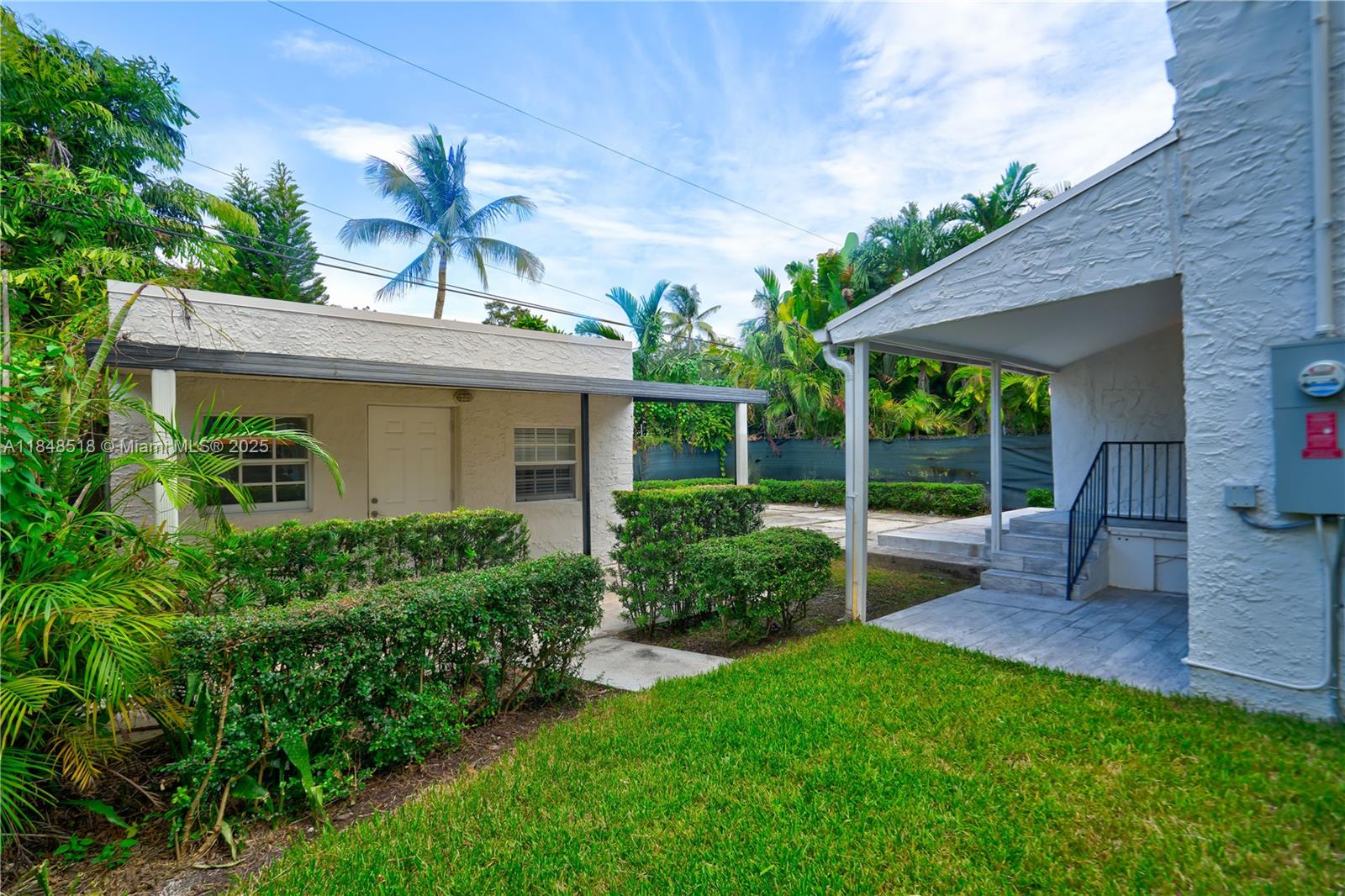 2217 Red Road Coral Gables, FL 33155 - Photo 8 of 33 a view of a house with a yard and potted plants