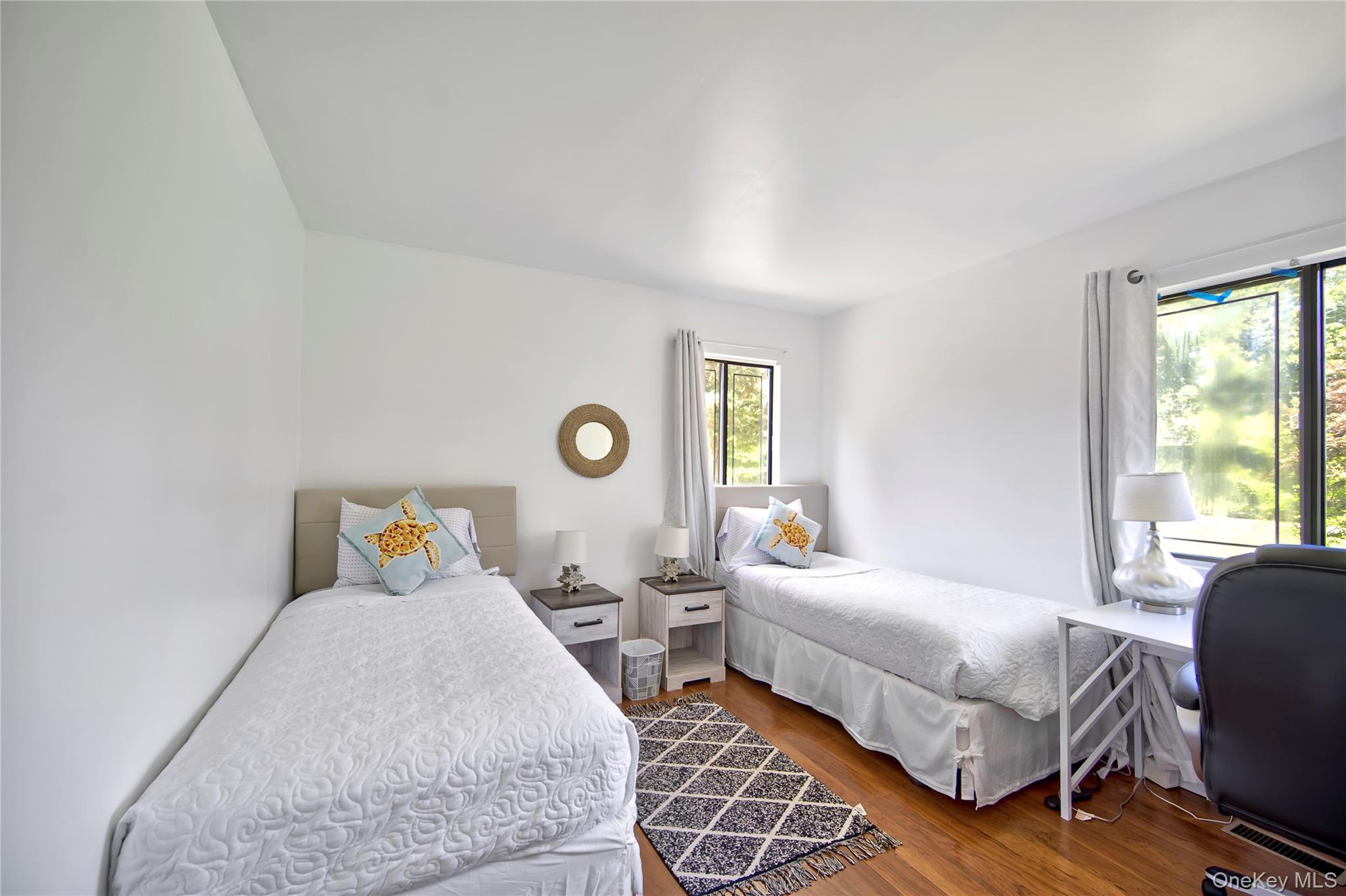 8 School Street Hampton Bays, NY 11946 - Photo 18 of 24 a bedroom with two beds and a window
