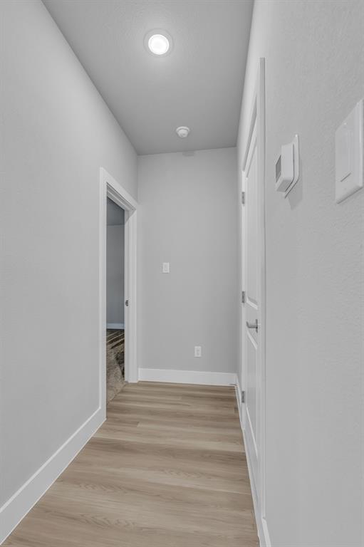 117 West Morton Street Denison, TX 75021 - Photo 16 of 29 Corridor featuring light hardwood / wood-style flooring