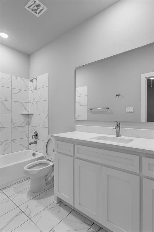 117 West Morton Street Denison, TX 75021 - Photo 20 of 29 Full bathroom featuring tiled shower / bath combo, vanity, and toilet