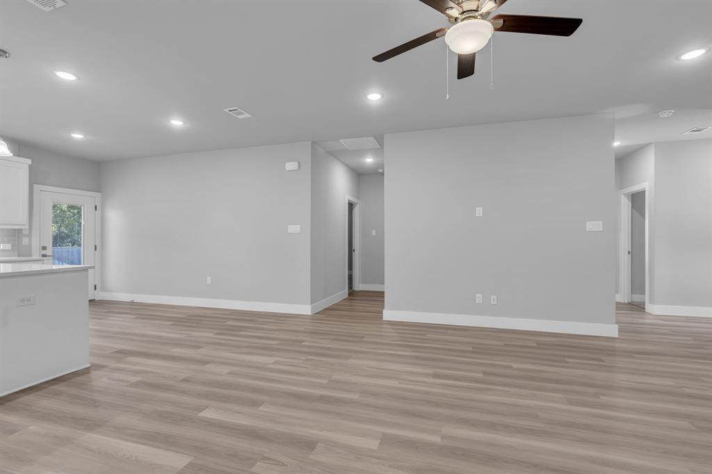 117 West Morton Street Denison, TX 75021 - Photo 9 of 29 Unfurnished living room featuring light hardwood / wood-style flooring and ceiling fan