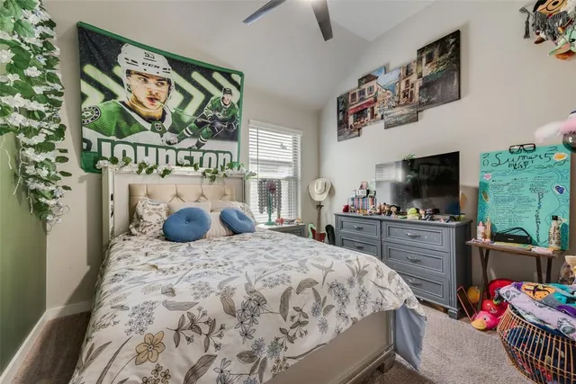 a bedroom with a bed and flat screen tv