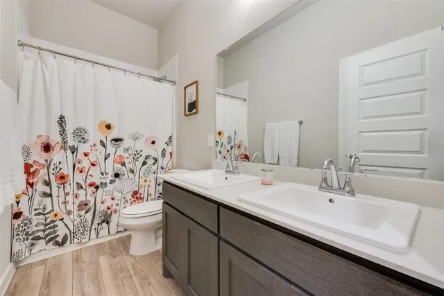 a bathroom with a sink toilet and shower