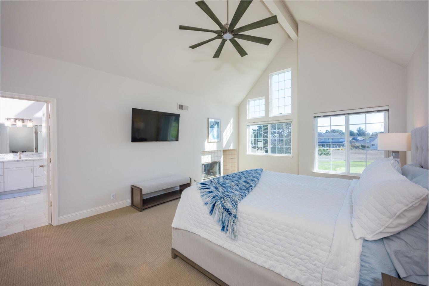 21 Merion Road Half Moon Bay, CA 94019 - Photo 19 of 35 a spacious bedroom with a bed and a flat screen tv